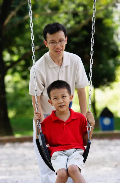 Father and son in playground — Stock Photo, Image