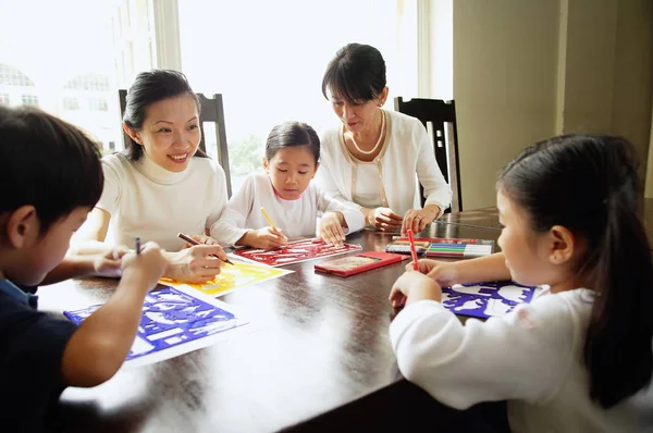 Children drawing, mother and grandmother — Stock Photo, Image