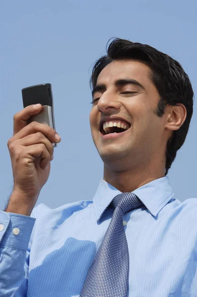 携帯電話を持つ若いビジネスマンは — ストック写真