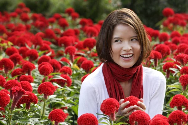 Woman among red flowers — Stock Photo, Image
