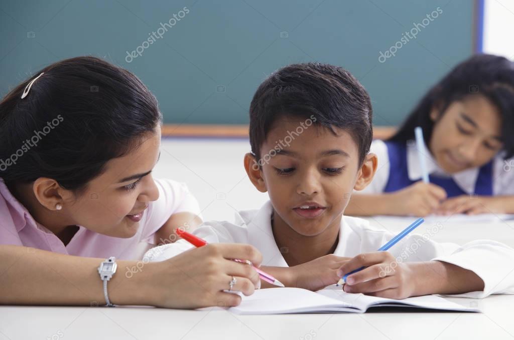 teacher helps student with schoolwork