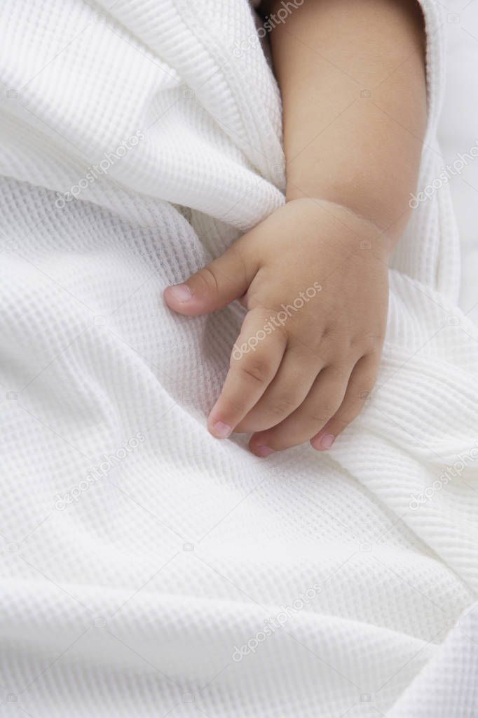 baby's hand on white