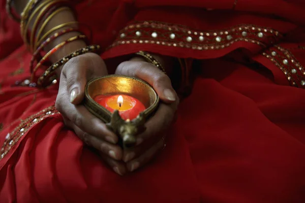 Woman holding lit candle — Stock Photo, Image