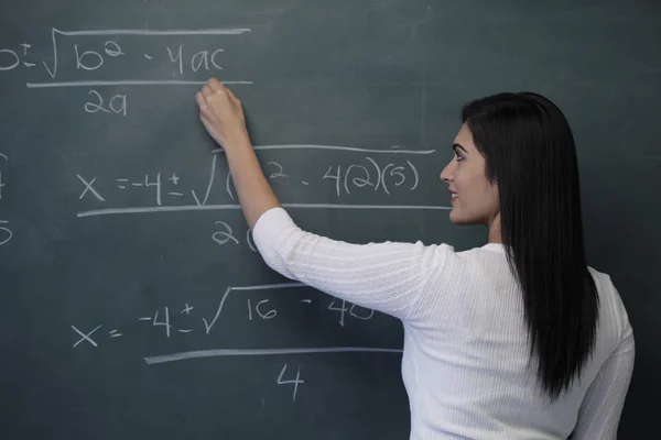 Young female teacher writing — Stock Photo, Image