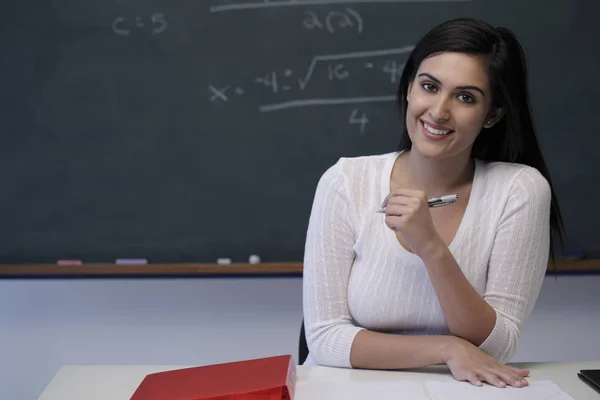 Young teacher sitting at classroom — Stock Photo, Image