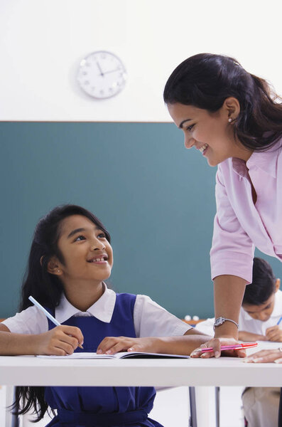 teacher with girl at classroom