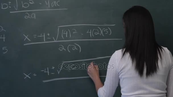 Woman writing mathematical formula — Stock Video