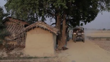 Adam traktör köyde toprak yol aşağı sürüş