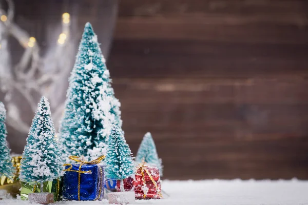 Julgranar med snö och gåva lådor - selektiv fokus — Stockfoto