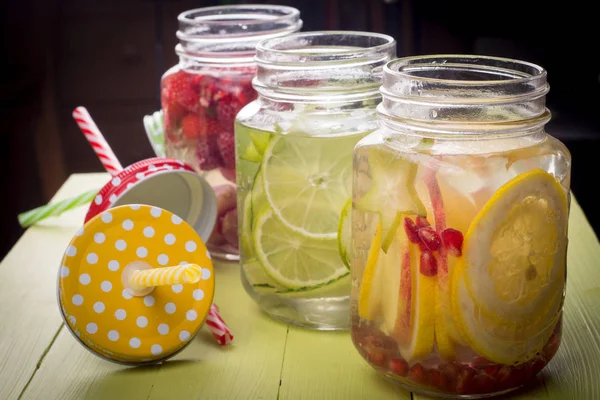 Fresh fruits flavored water in jars