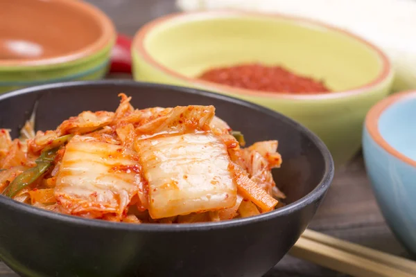 Kimchi or kimchee on black plate — Stock Photo, Image