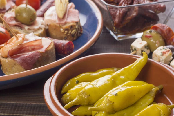 Pickled green peppers and tapas — Stock Photo, Image
