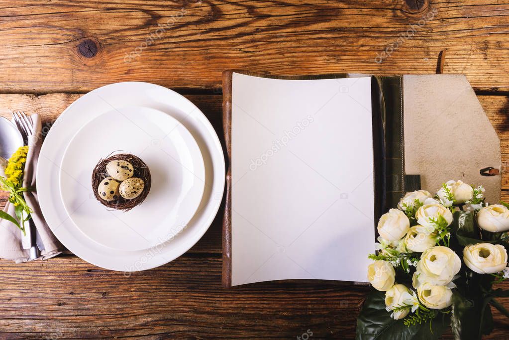 Easter menu on a wooden table decorated in eggs and fresh flower