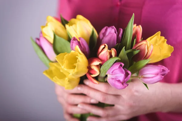 Woman with tulips in spring day