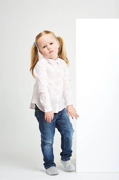 Beautiful little girl with white copy space on a white backgroun — Stock Photo, Image