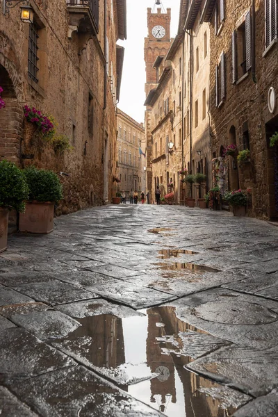 Rainy and sunny wet streets in Pienza.