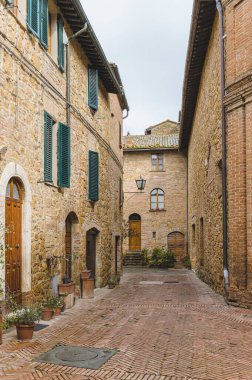 Yağmurlu bir günde güzel şehir Pienza, Toskana 'nın sokaklarında yürü.