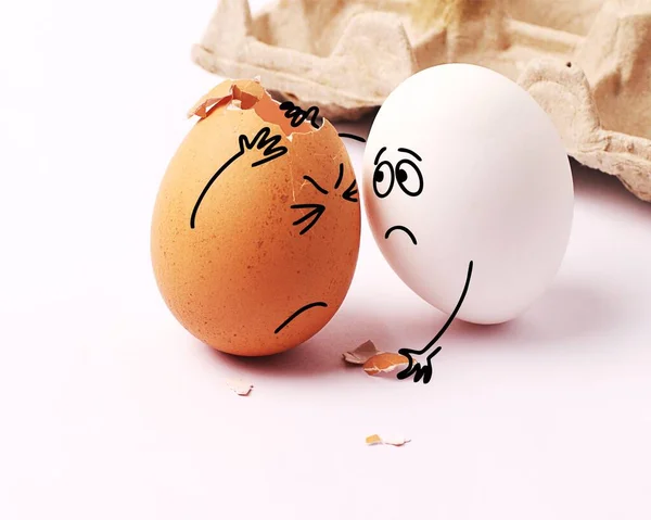 Two funny white eggs with faces drawn on them. Easter. Eggs with funny faces. Broken egg. My head hurts. Many problems. Pity, concern. — Stock Image Two Funny White Eggs Faces Drawn Them Easter Eggs Funny Stock Photo