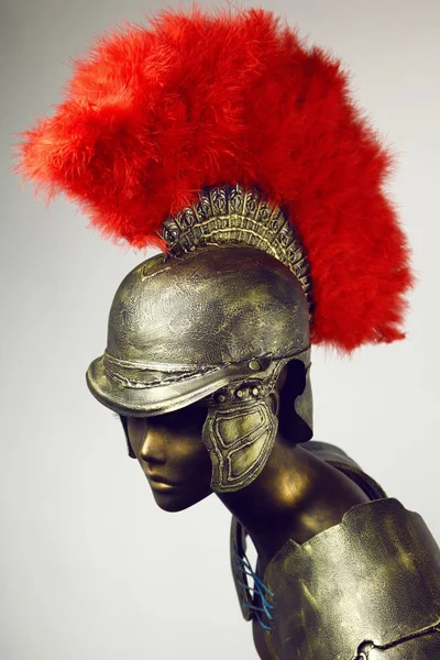 mannequin in roman centurion helmet with plume