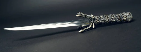 metal sword on black background