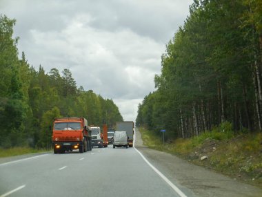 chelyabinsk, russia 06 06 2019: Ural mountains road with Russian cars. Cross the road through the jungle. 