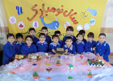 Rasht, Gilan, Iran, 05 05 2019. New Year's Eve Celebration at Boys' School in Iran. School students by Nowruz table. Students in school uniform at New Year's Eve. Norooz eve.