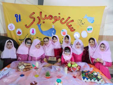 Rasht, Gilan, Iran, 05 05 2019. New Year Celebration at Girls' School in Iran. Nowruz table party with female students. Painted faces of students at the celebration.