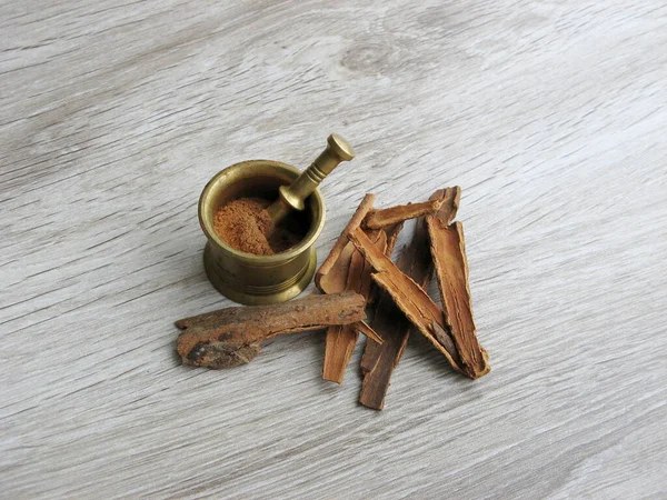 Cassia Cinnamon Sticks Powder Brass Mortar Wooden Background Cinnamon Useful Royalty Free Stock Images