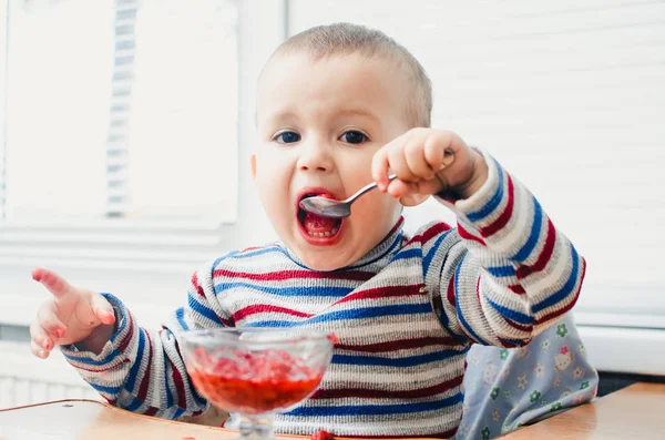 Child eating red jam