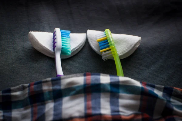 two toothbrushes on a cotton disks .as for the pillows
