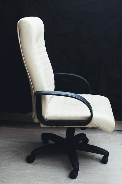 white armchair on black background