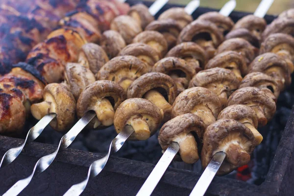 Appetizing mushrooms are grilled. Vegan shish kebab. Copy space