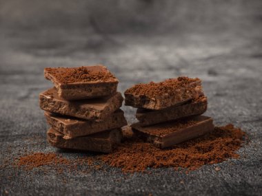 Kırık çikolata parçaları üzerine kahve tozu serpiştirilmiş..