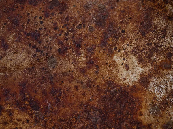 Yellow brown rust and dirt on white enamel. Rusted brown abstract texture. Corroded metal background. Rusty white painted metal surface.