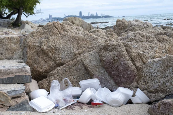 Müll neben Steinen am Strand versteckt — Stockfoto