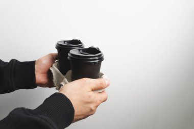 Coffee in coffee cup in mans hands