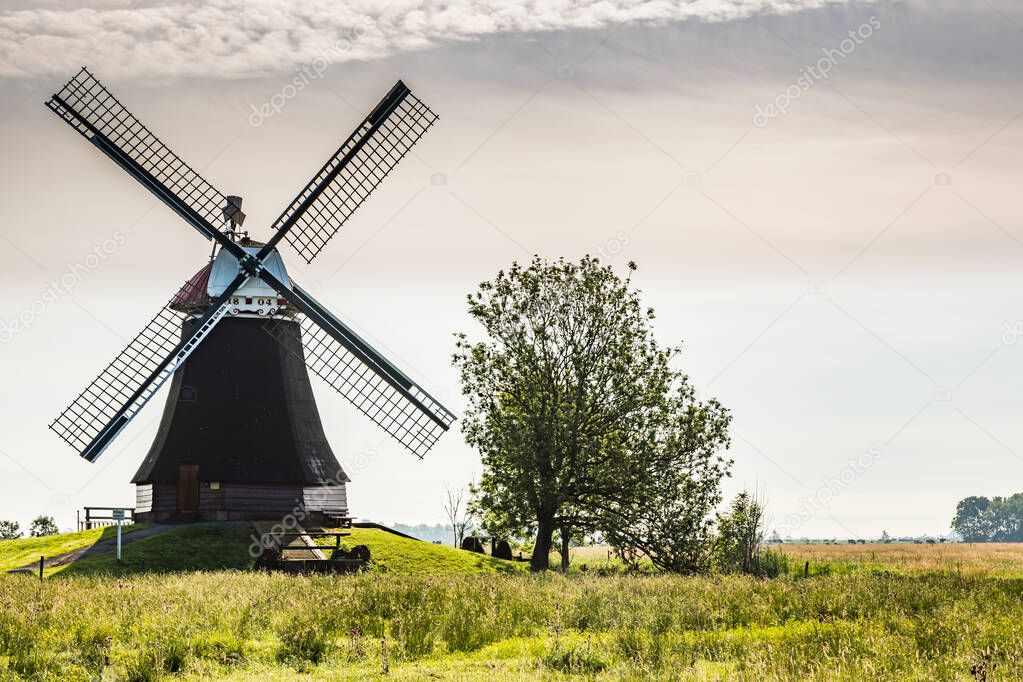 Windmill Wynhamster Kolk. East Frisian landscape with mill near the town of Leer, East Frisia, Lower Saxony, Germany 