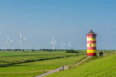 Pilsum Lighthouse with Wind Turbines, North Sea, East Frisia, Germany clipart