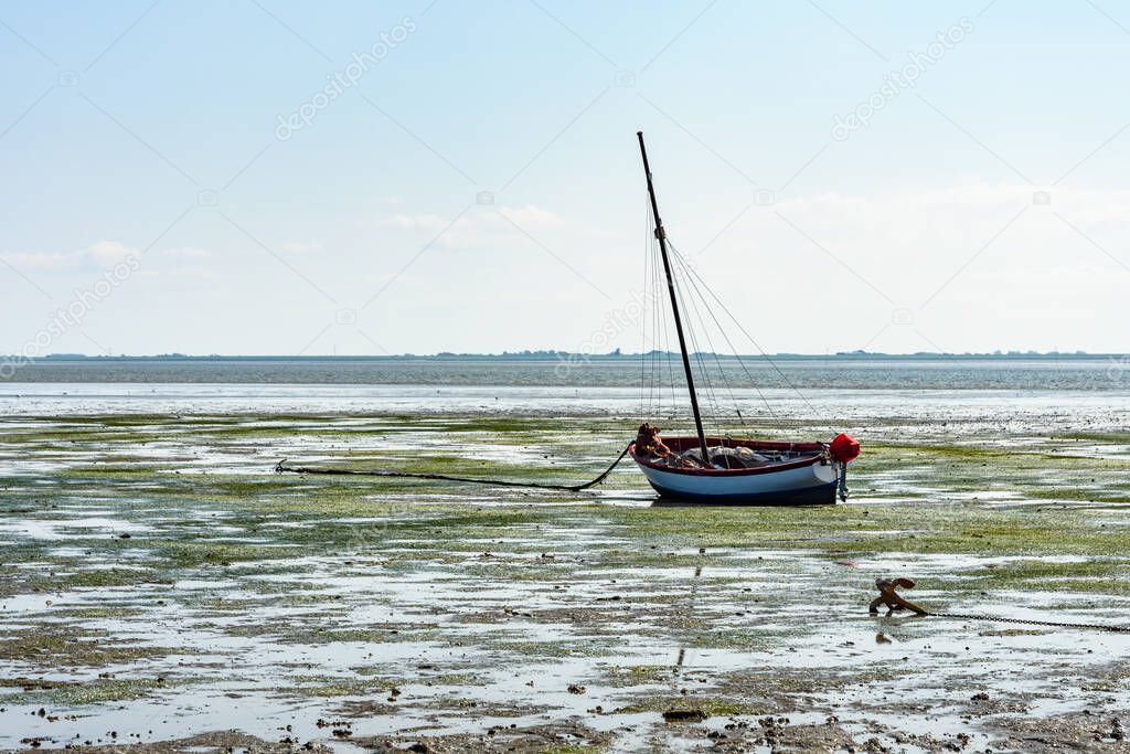 Boat at he Wadden Sea at Low Tide, Hallig Hooge, Schleswig-Holstein Wadden Sea National Park, North Frisia, Germany