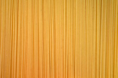 İnce spagetti yakın çekim üst manzara. Pişmemiş spagetti arka planı, un ürünleri..