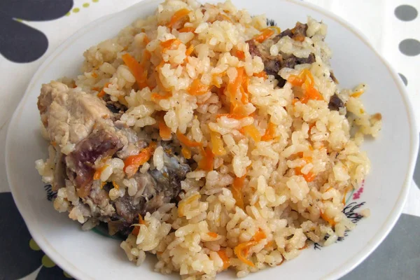 homemade pilaf with rice, carrots and meat
