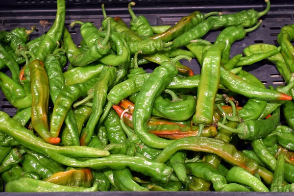 Top view of green chili peppers background.  bunch of spicy green hot chili peppers on the store counter in the vegetable department