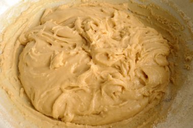 knead the dough in a bowl to make a cake. batter. baking at home, homemade, shortcrust                          