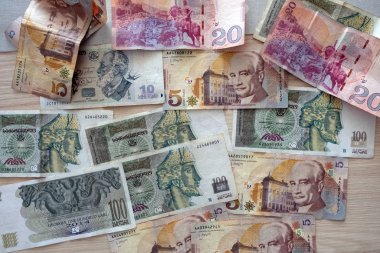 Georgian bills of different denominations on the table top view. Georgia paper money in 2020. Banknotes in denominations of 100, 10, 5 and 20 on a wooden background.