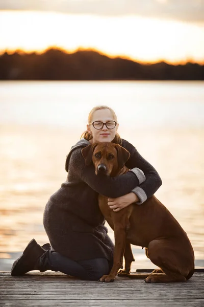 Meisje Hond Knuffelen Zonsondergang Licht Water Achtergrond Vriendschap Concept — Stockfoto