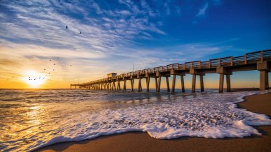 sunset at the pier of venice, florida clipart