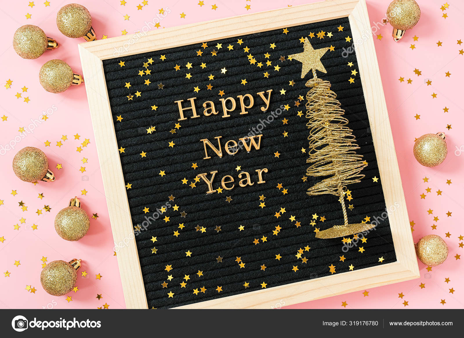 Letter board with golden text Happy New year and shiny christmas tree