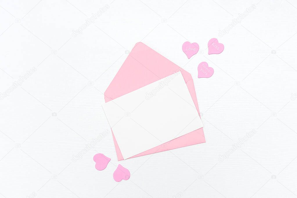 Love Letter. Pink envelope with white blank card and hearts on white background. Top view Flat lay Mockup for your text. Valentines day, Mothers day, Womens day greeting card