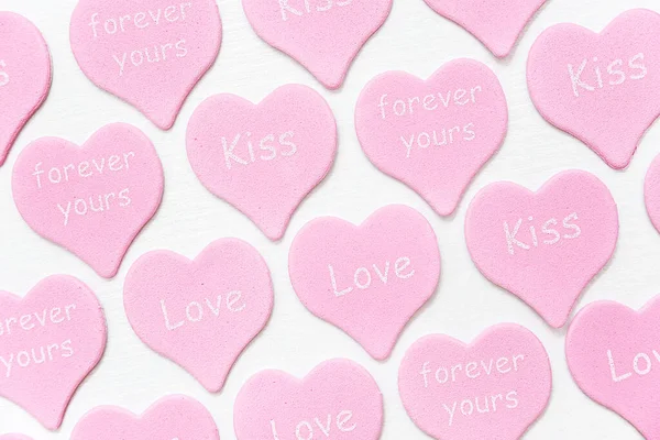Rosa Herzen mit Text Liebe, Kuss, für immer dein auf weißem Hintergrund. Valentinstag Textur oder Tapete. Geschenk für Liebhaber, Liebesgeständnis. von oben flach liegend — Stockfoto