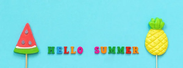 Hello Summer Colorful Text Pineapple Armelon Lollipops Stick Blue Paper — стоковое фото